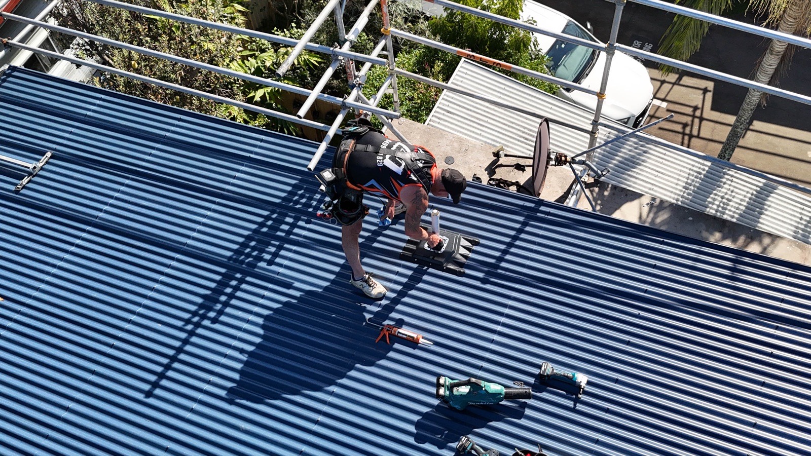 Aerial view of Shawn installing a Penenator on the Bribie Island roof